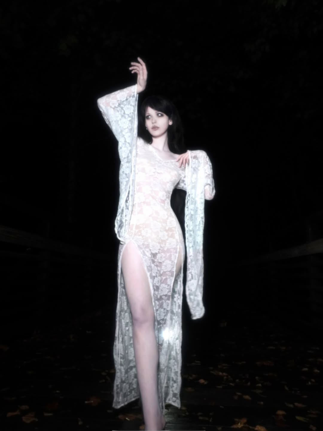 Lifestyle shot of model in the woods wearing white, lace maxi dress, showcasing dual leg slits and flared drop sleeves. On model - Cascadia (Ivory) - FM2U Clothing Australia | Gothic Alternative Whimsical Ethical Fashion