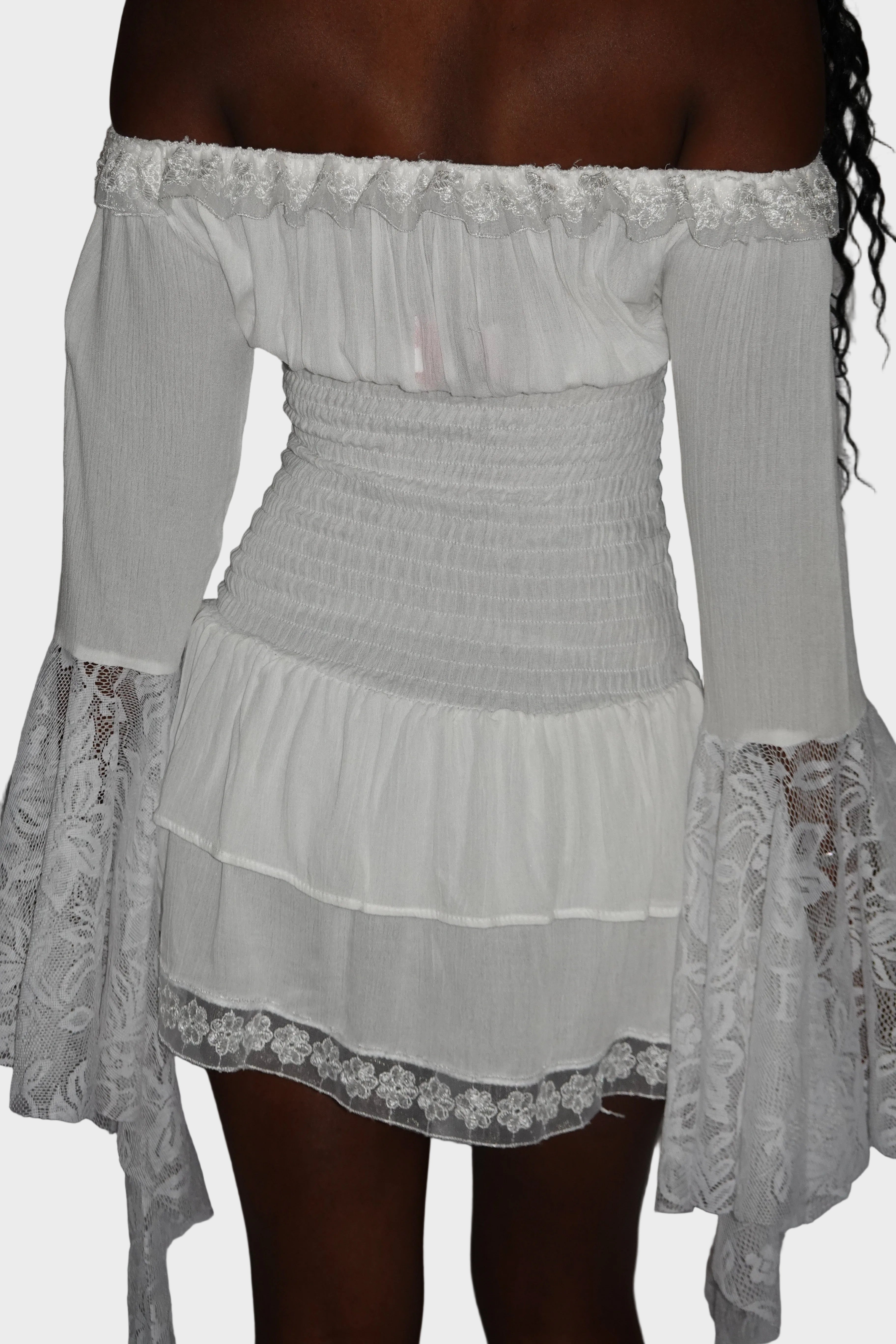 Back view of white mini dress with shirred drop wait, tiered skirt, and lace detailing. On model - Milkmaid mini dress (Ivory) - FM2U Clothing Australia | Gothic Alternative Whimsical Ethical Fashion