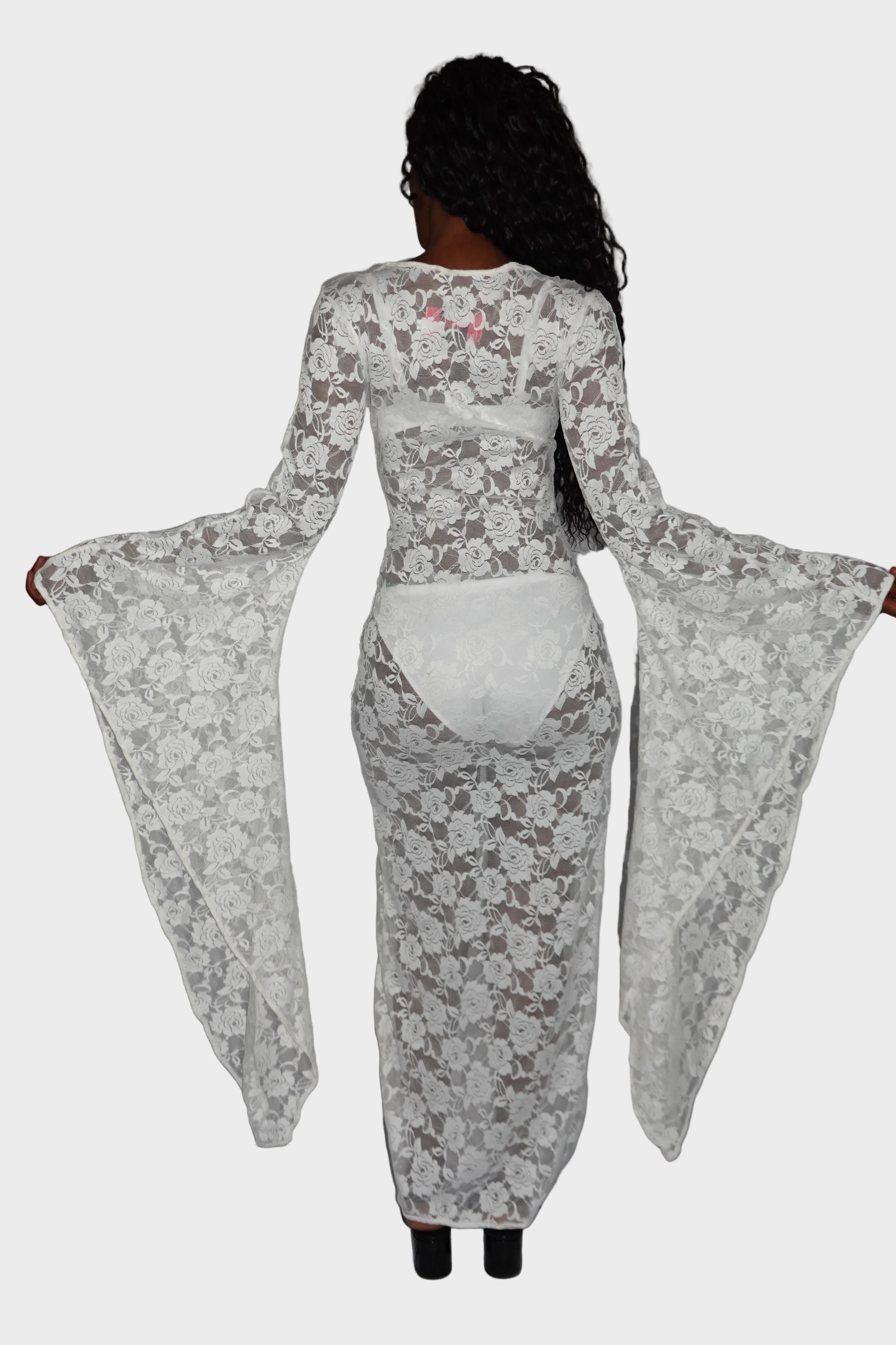 Back-view of white, rose-patterned, lace maxi dress showcasing flared drop sleeves and comfortable stretch fit. On model - Cascadia (Ivory) - FM2U Clothing Australia | Gothic Alternative Whimsical Ethical Fashion