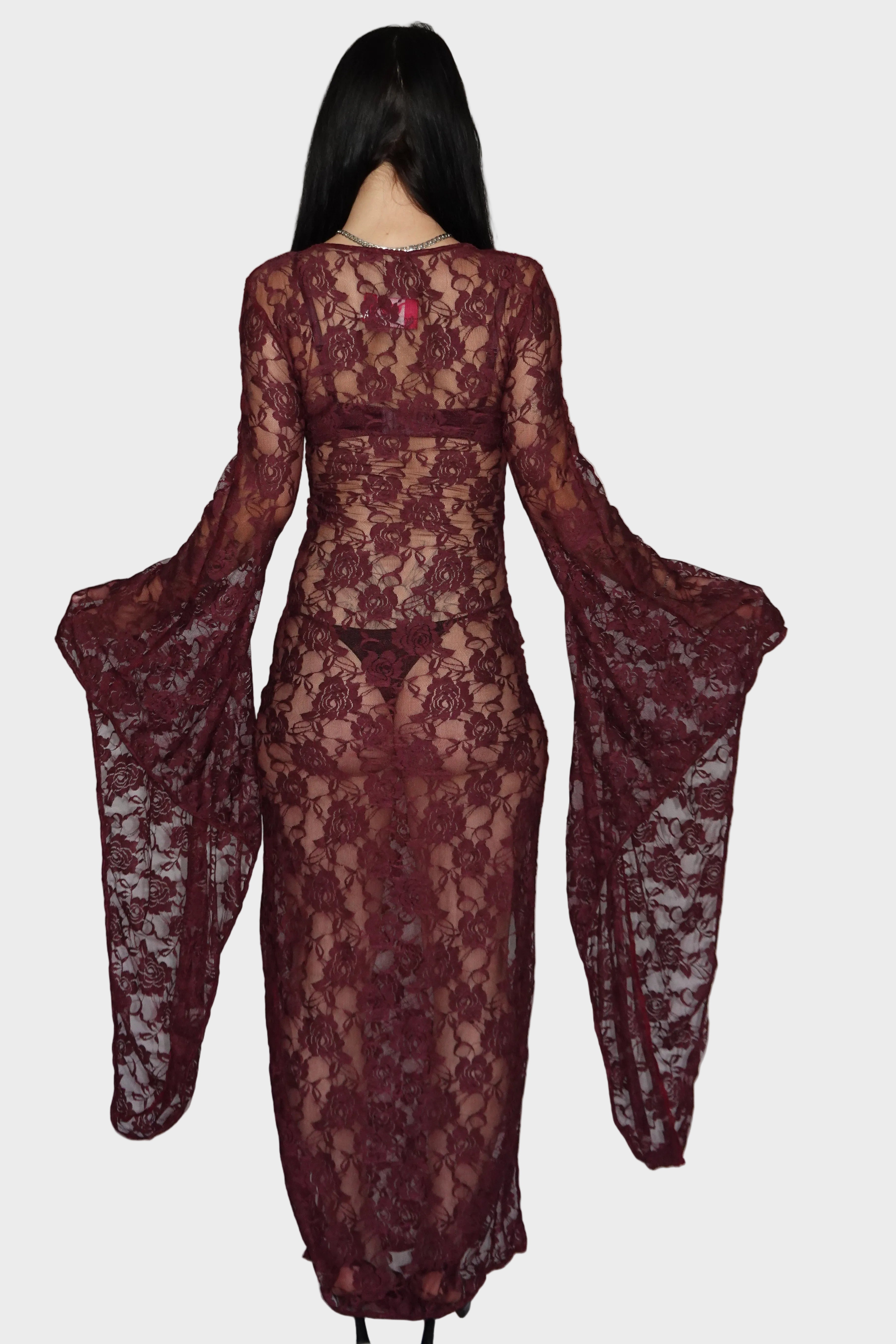 Back view of deep purple, rose-patterned sheer maxi dress with long whimsical cascading flared sleeves. On model - Cascadia (Purple) dress - FM2U Clothing Australia | Gothic Alternative Whimsical Ethical Fashion